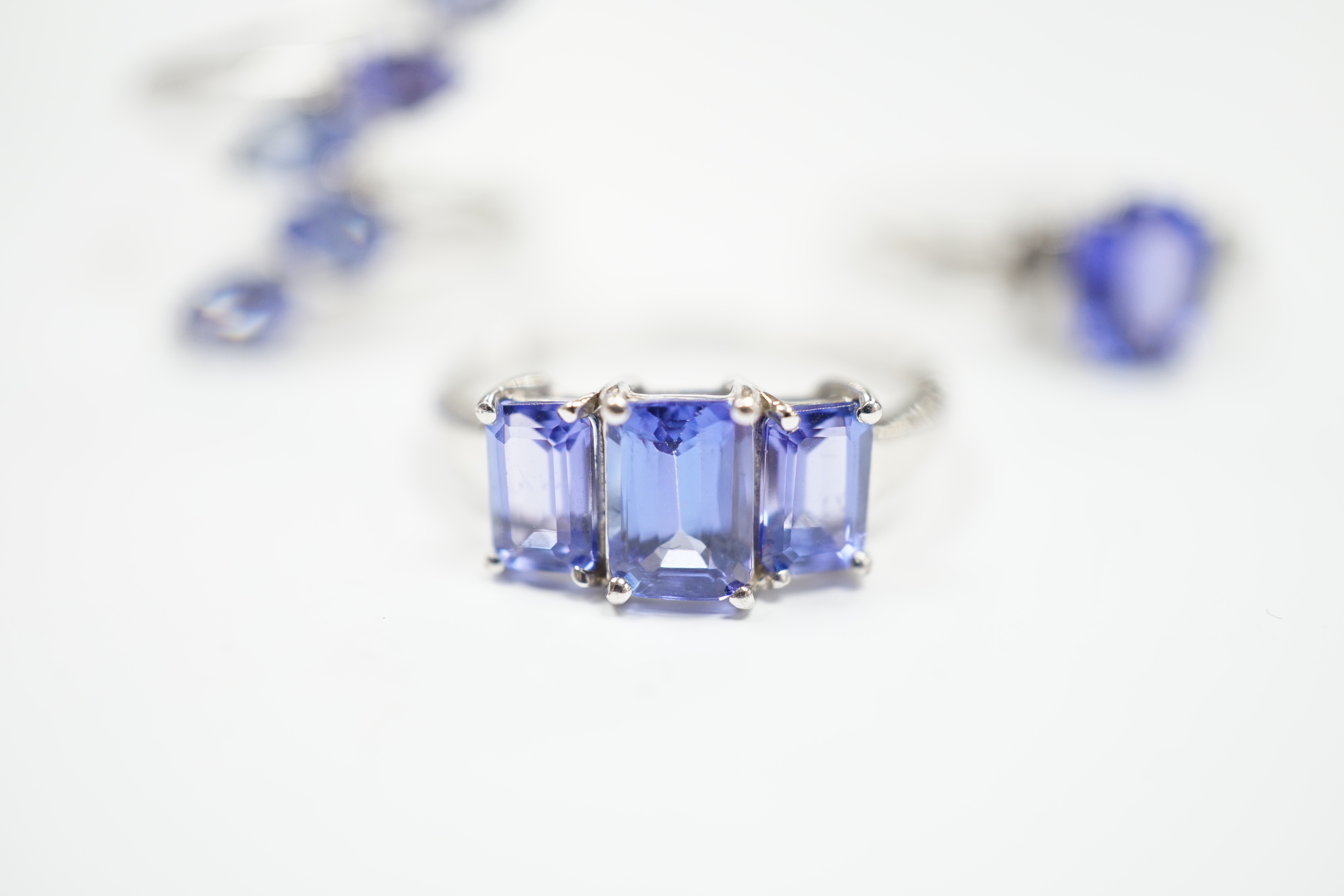 Three assorted modern 9ct white gold and tanzanite set dress rings, gross weight 8.4 grams.